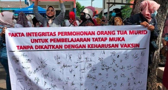 DOKUMEN. Orang tua siswa si Padang melakukan demonstrasi menuntut peraturan Walikota Padang yang mewajibkan siswa SD vaksin agar bisa masuk belajar di sekolah.