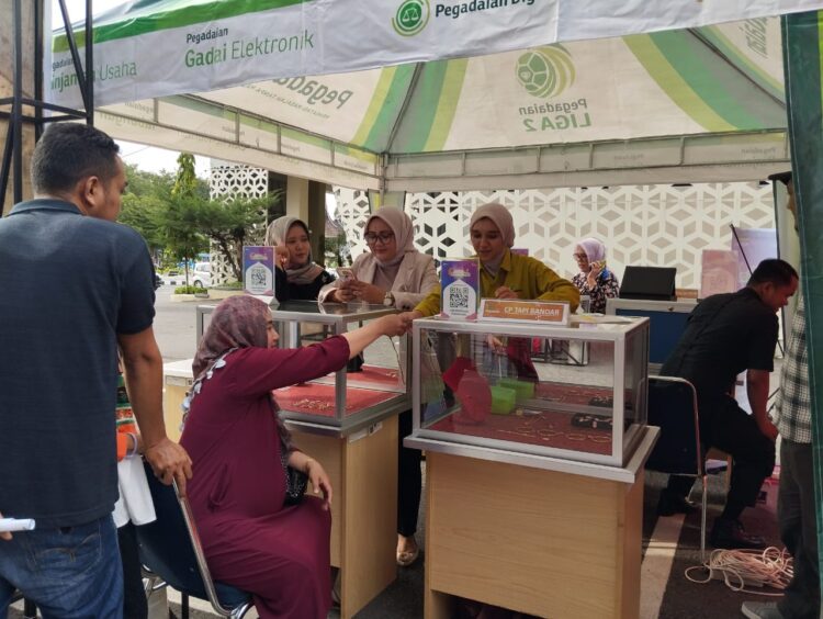 Pengunjung Bazar, Deliza (37) saat melakukan pembelian emas di bazar emas. YESI