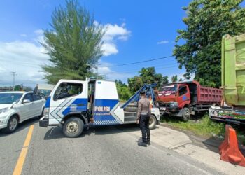 Satlantas Polres Padang Pariaman mengevakuasi truk usai kecelakaan dengan bis tranek. ALDI