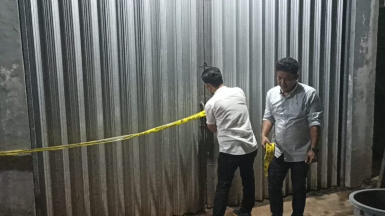 Personel Satreskrim Polres Sijunjung memasang garis polisi di lokasi karung pupuk nonsubsidi yang dijual secara illegal, Rabu (12/6). IST