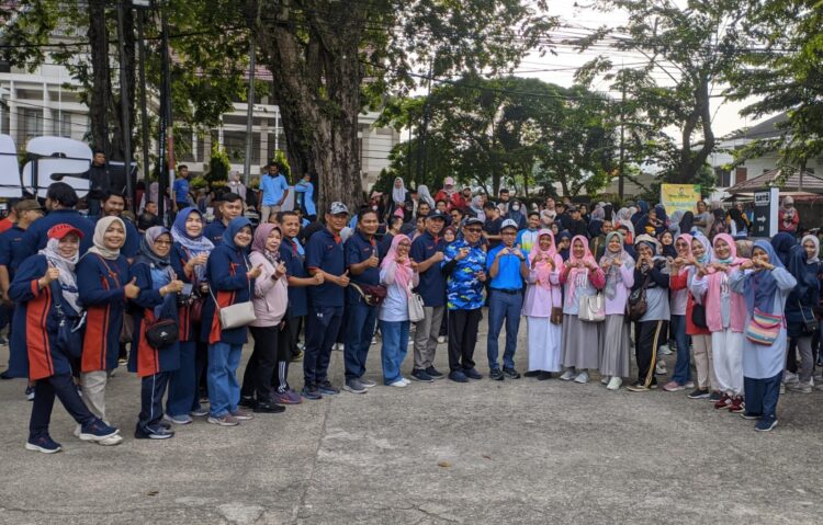 Rektor UNAND Efa Yonedi bersama dengan sejumlah masyarakat foto bersama saat menggelar serangkaian kegiatan untuk memperingati hari kanker sedunia pada kegiatan car free day, Minggu (2/2). Ipat